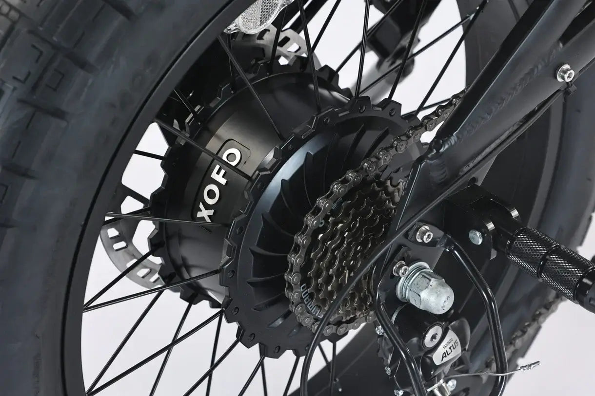 Close-up of the rear wheel hub motor on the GhostCat F4X Pro fat tire electric bike, showcasing its powerful design.