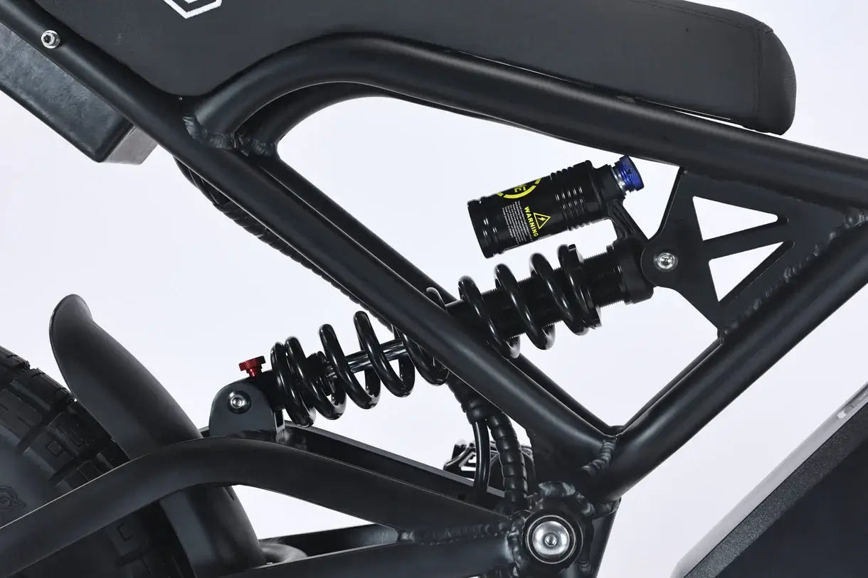 Close-up of the suspension system on the GhostCat F4X electric bike, showcasing its advanced shock absorber design.