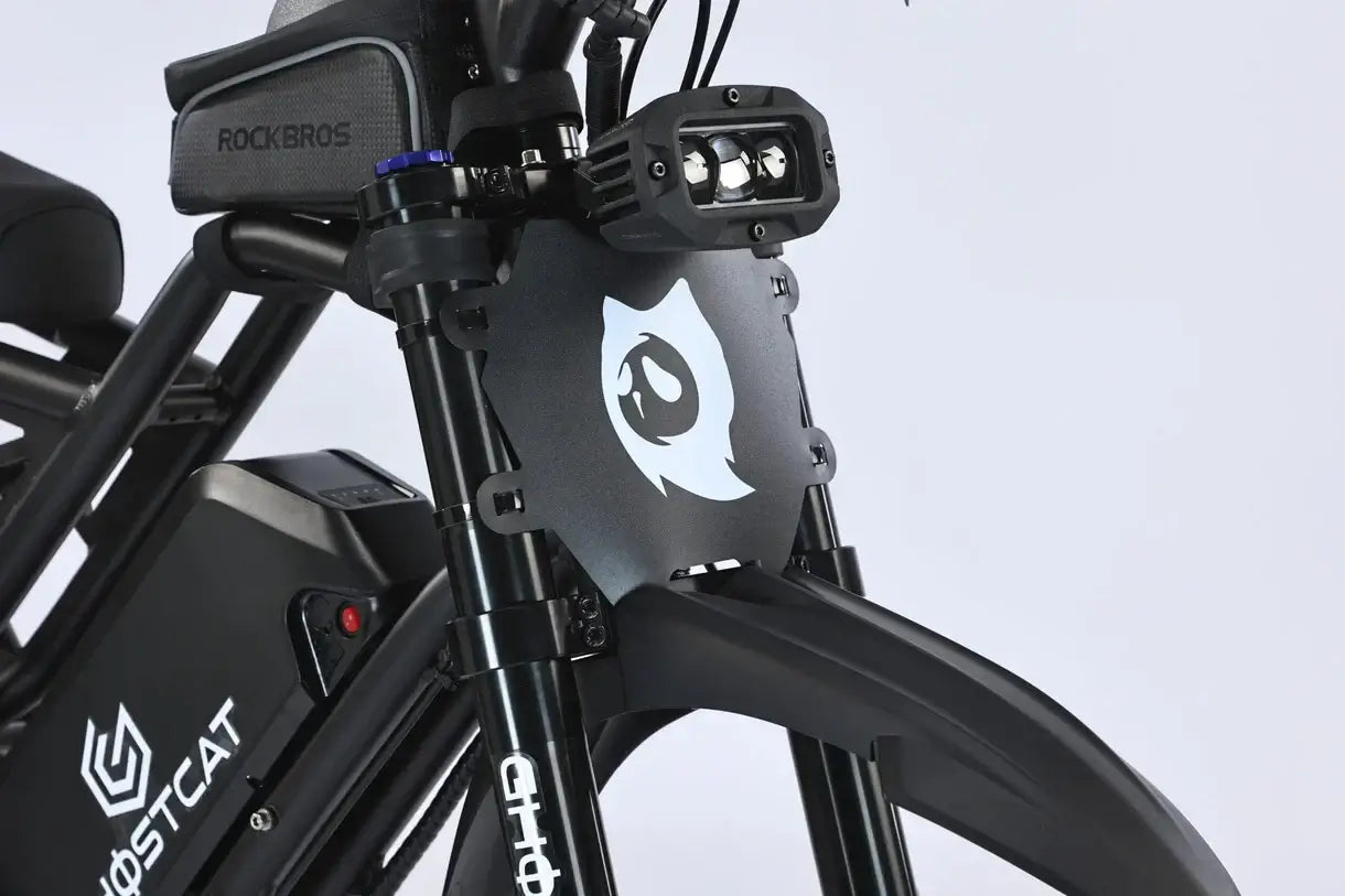 Close-up of the GhostCat F4X Pro electric bike's front fork with logo and light mount.