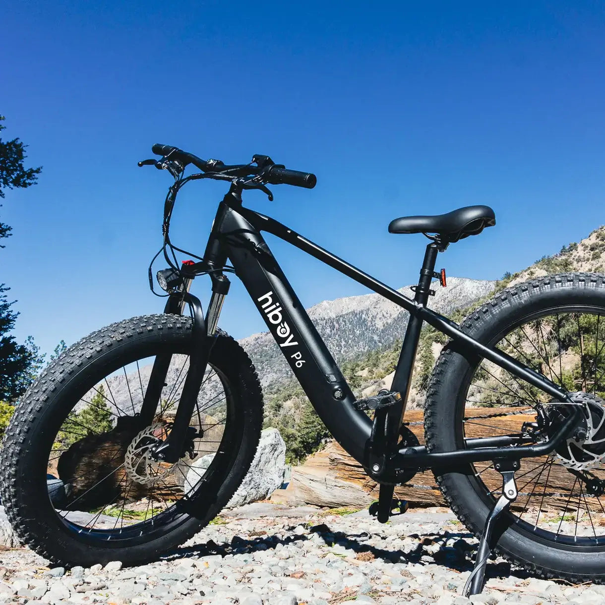 Hiboy P6 E-Bike in a scenic landscape, showcasing its fat tires and sturdy design for off-road adventures.