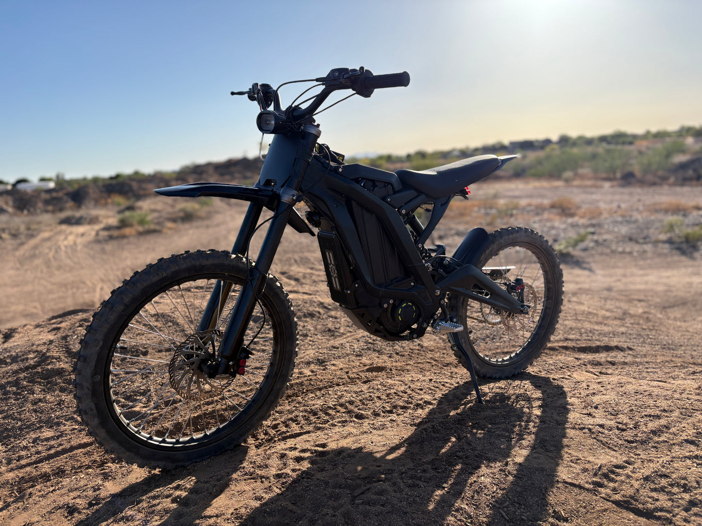 Natkie N1 Electric E Moto in Desert with sun setting.