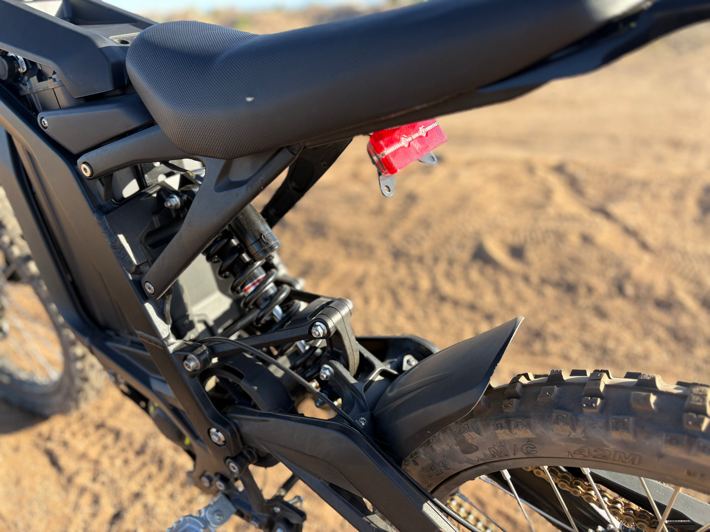 Natkie N1 Electric E Moto in Desert showing rear suspension.