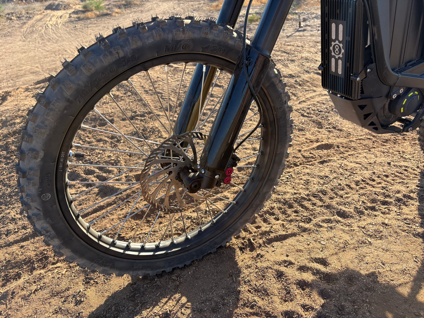 Natkie N1 Electric E Moto in Desert showing front wheel.
