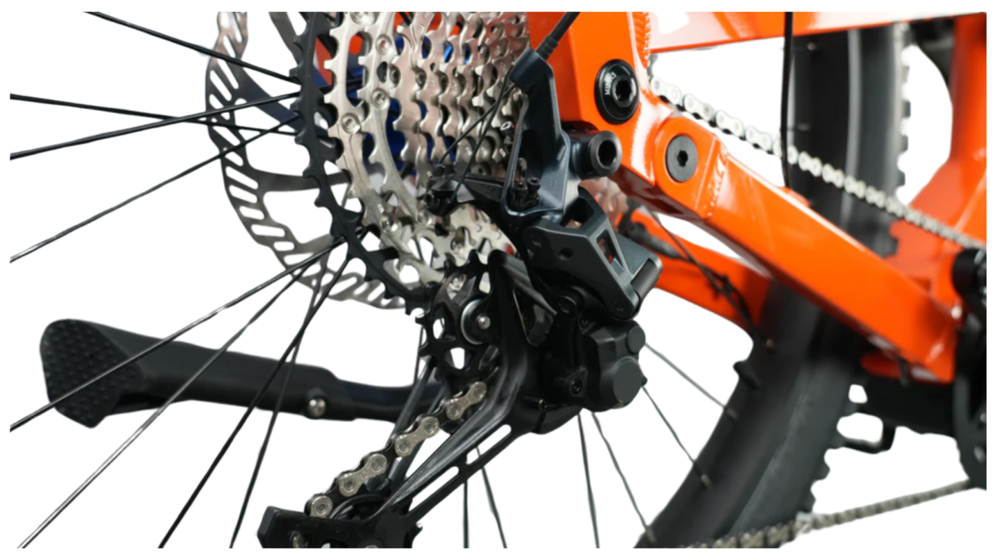 Close-up of the rear derailleur and cassette on the 2025 CyberBike Raptor Pro in Sunset Orange.