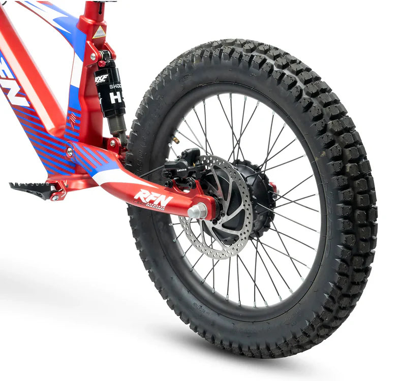 Close-up of RFN Evo Racing 18 Electric Kids Bike rear wheel showing tire tread and disc brake for performance safety.