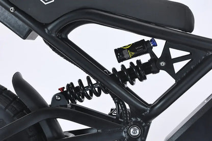 Close-up of the suspension system on the GhostCat F4X electric bike, showcasing its advanced shock absorber design.