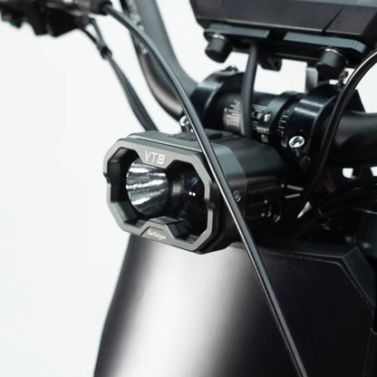 Close-up of the powerful VTB headlight on a Ventus V1+ electric dirt bike, showcasing advanced design and brightness.