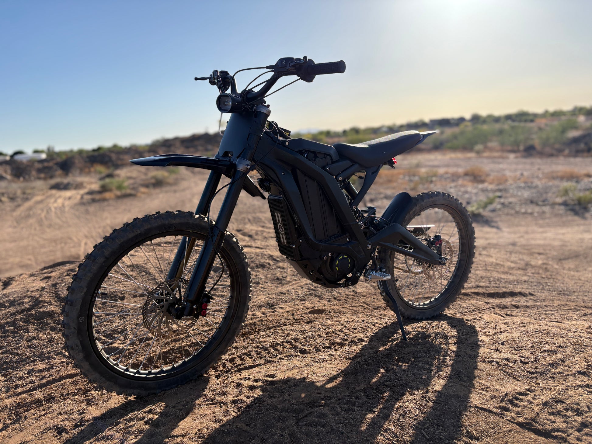 Natkie N1 Electric E Moto in Desert with sun setting.