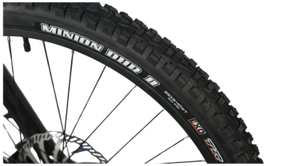 Close-up of a Minion DHR II mountain bike tire showcasing its tread design and sidewall.
